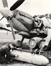 Pilot watches men fill a fuel tank with beer for D-Day troops, 1944