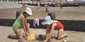 Girls make sandcastles on the beach, Worthing c1971
