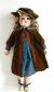 Doll with hair, hat, dress, coat and shoes